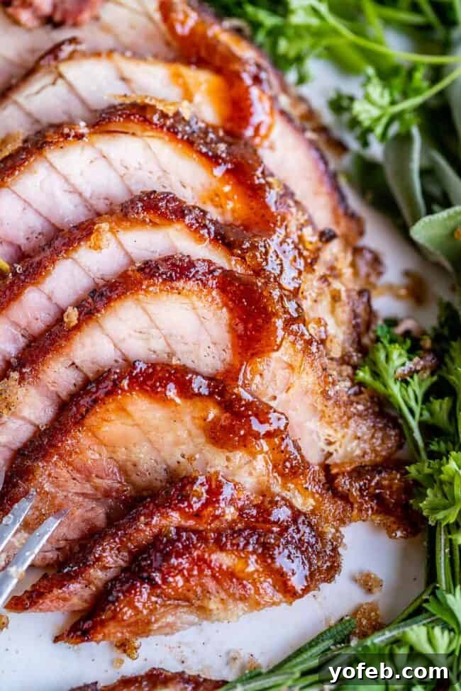 Ultimate Honey Baked Ham 4 Honey baked ham recipe (copycat) presented sliced on a plate, ready to serve.