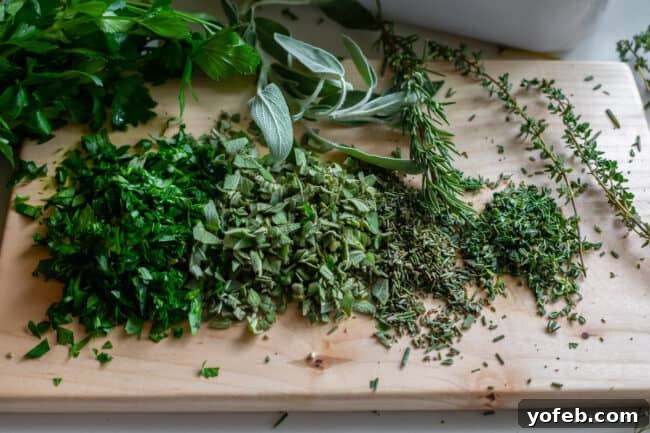 The Ultimate Thanksgiving Stuffing 14 parsley, sage, rosemary and thyme shopped on a cutting board
