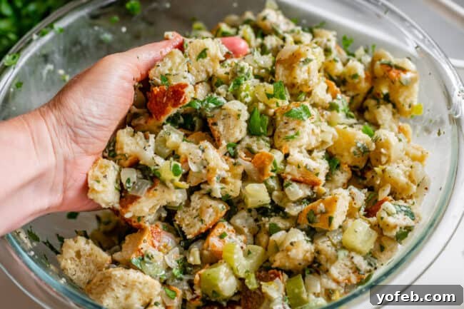 The Ultimate Thanksgiving Stuffing 18 hand mixing raw stuffing together in a bowl