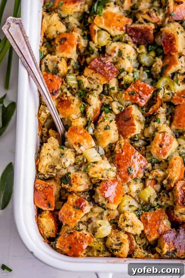 The Ultimate Thanksgiving Stuffing 3 thanksgiving stuffing in a white dish with a spoon, over head