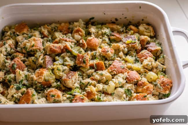 The Ultimate Thanksgiving Stuffing 20 raw stuffing spread out in a white casserole dish
