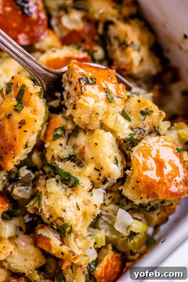 The Ultimate Thanksgiving Stuffing 4 spoon digging into traditional stuffing recipe