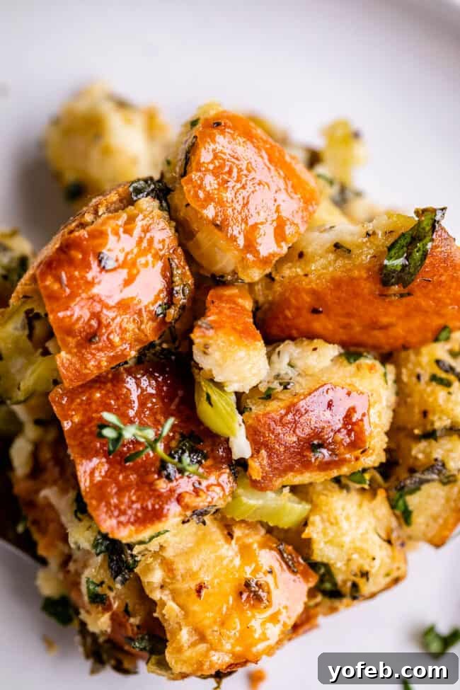The Ultimate Thanksgiving Stuffing 5 overhead shot of homemade stuffing recipe with herbs on a plate