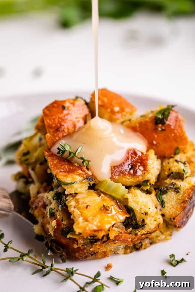 The Ultimate Thanksgiving Stuffing 8 easy stuffing recipe being drizzled with gravy on a plate
