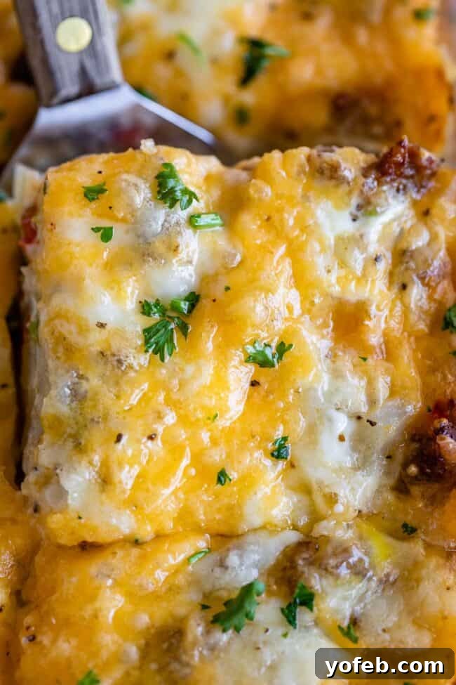 The Ultimate Sausage Breakfast Casserole 12 sausage and egg breakfast casserole with parsley sprinkled on top.