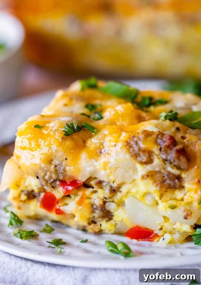 The Ultimate Sausage Breakfast Casserole 3 breakfast sausage casserole with peppers and onions on a plate sprinkled with parsley.