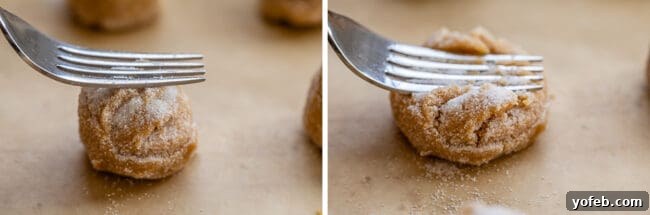 Melt-in-Your-Mouth Peanut Butter Cookies 10 Pressing a peanut butter cookie with a fork to create the traditional criss-cross pattern before baking, an essential step for this easy recipe.
