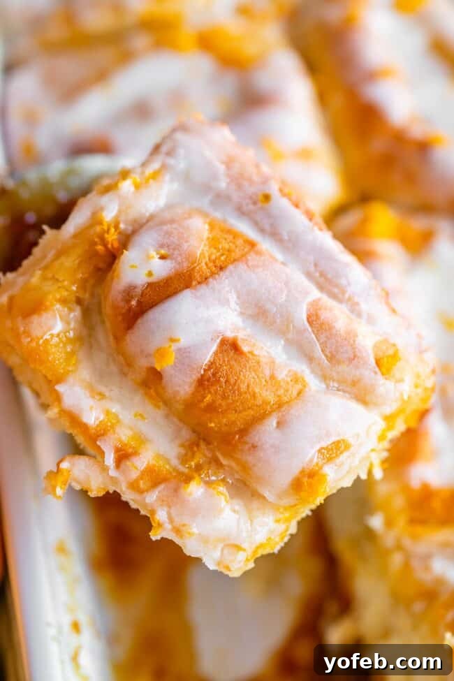Meyer Lemon Sunshine Rolls 5 meyer lemon sweet roll being lifted from a white pan