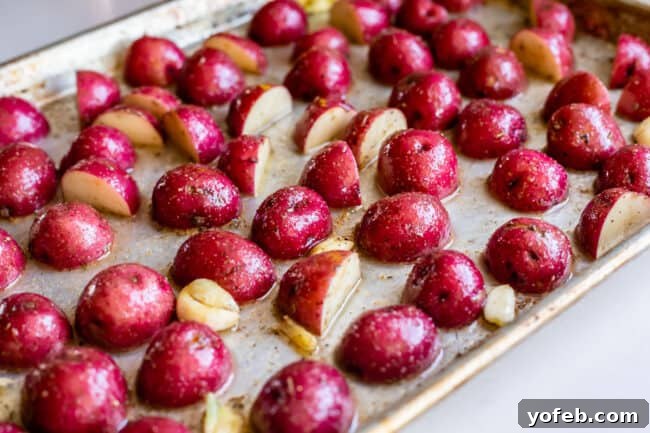 Crispy Oven-Roasted Red Potatoes 10 cut red potatoes coated in oil and spices, arranged meticulously cut-side down in a single layer on a baking sheet