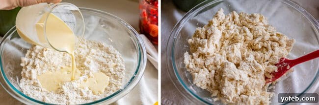 Adding cold buttermilk to a bowl containing a mixture of flour and butter, then stirring gently with a red spatula.
