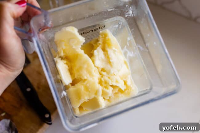 Island Oasis Piña Colada 17 A partially frozen piña colada mixture sits in a blender, ready for its final blend to achieve ultimate creaminess and frostiness.
