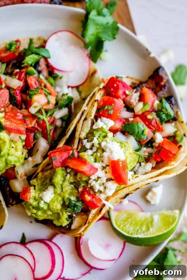 Mastering Carne Asada 17 carne asada, guacamole, and pico de gallo in a taco, on a plate with radishes.