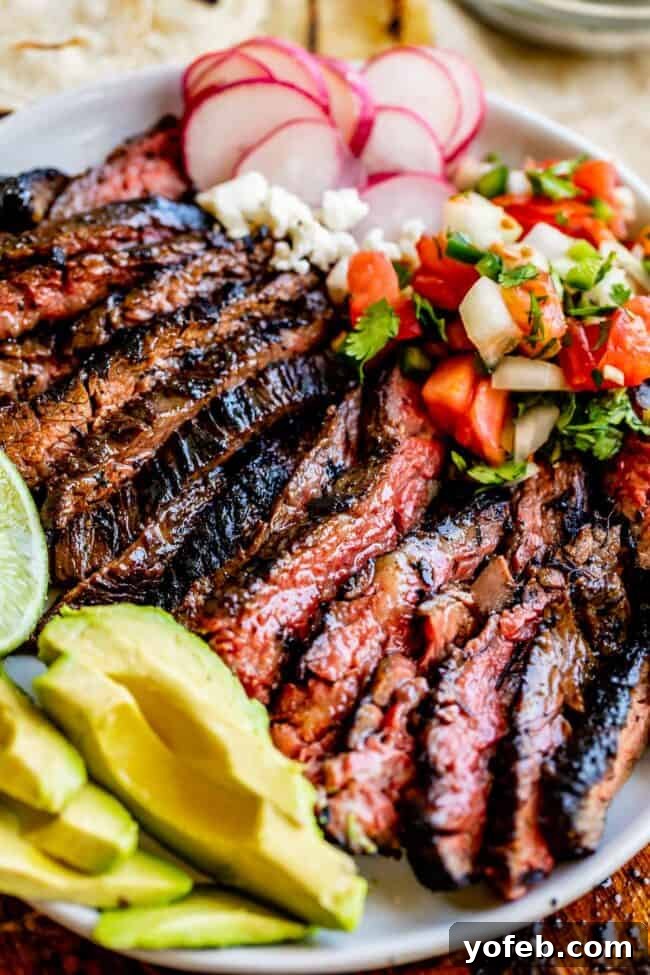 Mastering Carne Asada 3 carne asada recipe on a place with garnishes.