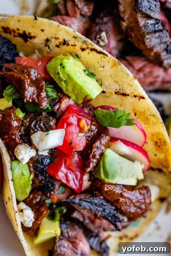 Mastering Carne Asada 21 carne asada in a taco with avocados and pico de gallo.