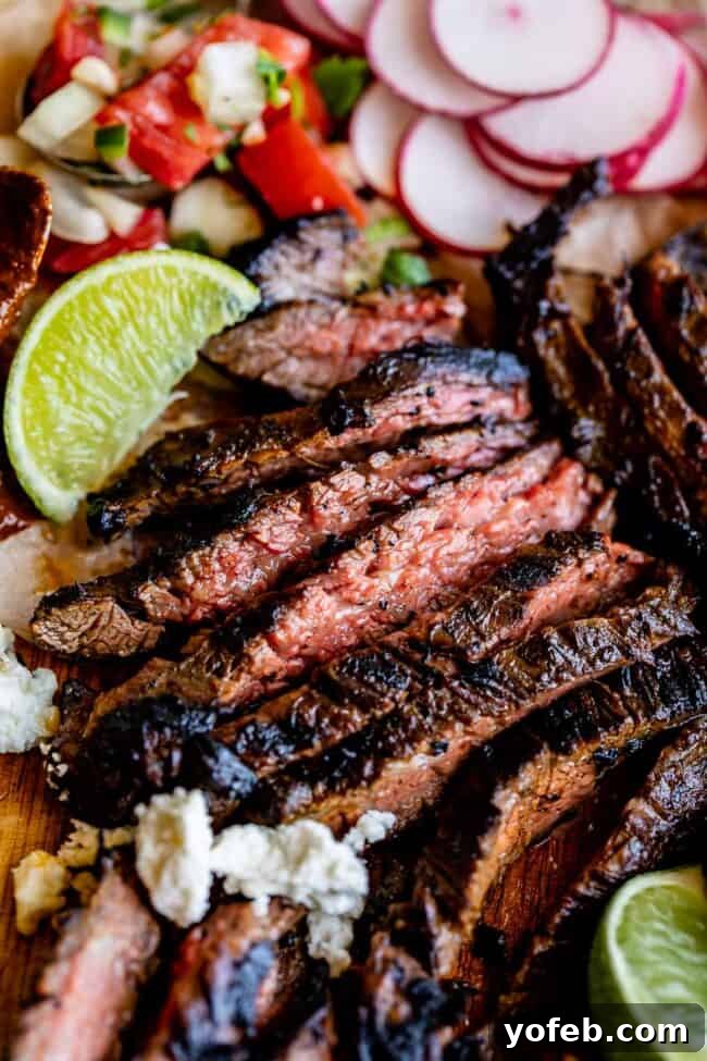 Mastering Carne Asada 6 sliced carne asada with limes and pico de gallo.