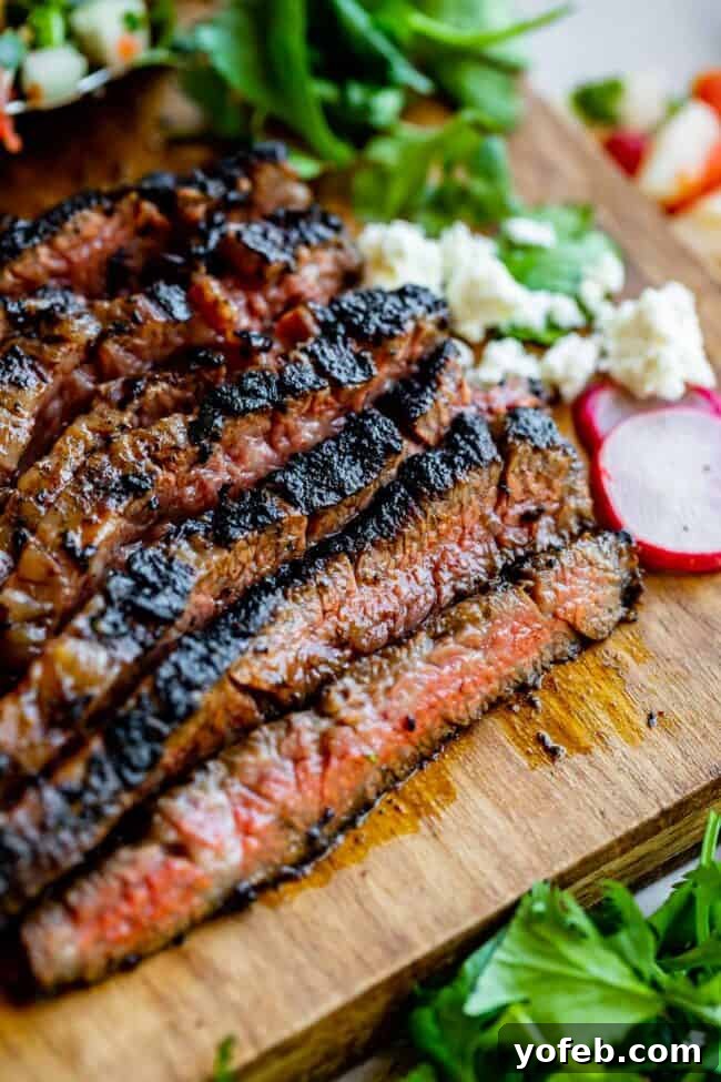 Mastering Carne Asada 7 carne asada meat sliced against the grain on a wooden cutting board.