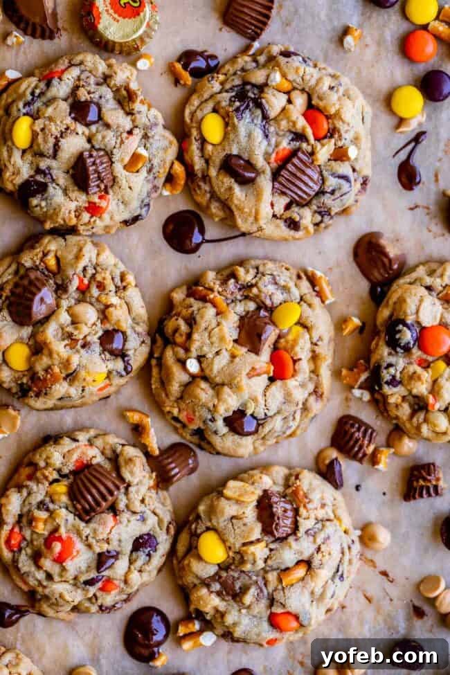 Loaded Reese's Peanut Butter Pretzel Cookies 3 Overhead shot of freshly baked Reese's peanut butter cookies on a baking sheet, loaded with various mix-ins.