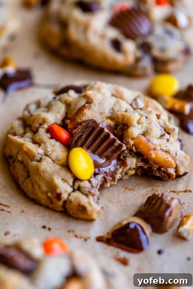 Loaded Reese's Peanut Butter Pretzel Cookies 7 Finished Reese's peanut butter cookies on a cooling rack, showcasing the mix of Reese's Pieces and pretzels.