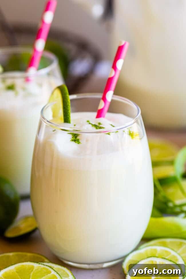 Creamy Brazilian Lemonade Recipe 2 A refreshing glass of Brazilian Limeade, also known as Brazilian Lemonade, garnished with a pink polka dot straw, ready to be enjoyed.