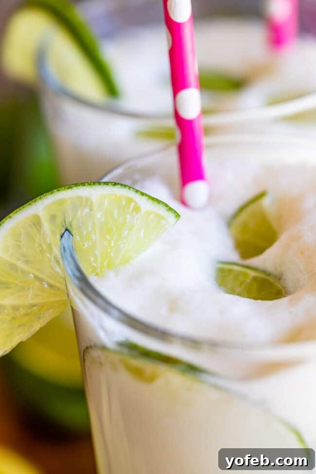 Creamy Brazilian Lemonade Recipe 16 A glass of Brazilian Limeade showcasing its signature frothy top, indicating a perfectly blended and refreshing drink.