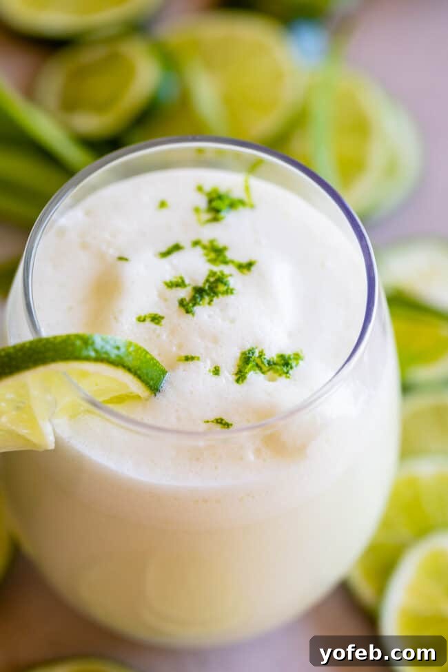 Creamy Brazilian Lemonade Recipe 7 A pristine glass of Brazilian Limeade, elegantly garnished with a swirl of lime zest, ready to be savored.