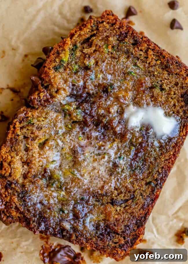 Heavenly Zucchini Bread 23 a slice of zucchini bread with melted butter on it.