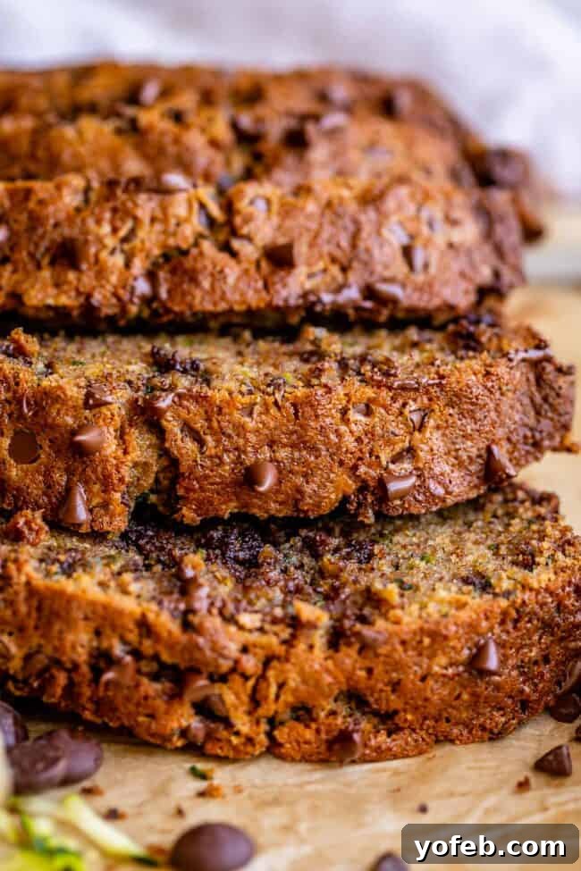 Heavenly Zucchini Bread 4 closeup side view of a few pieces of zucchini bread stacked.