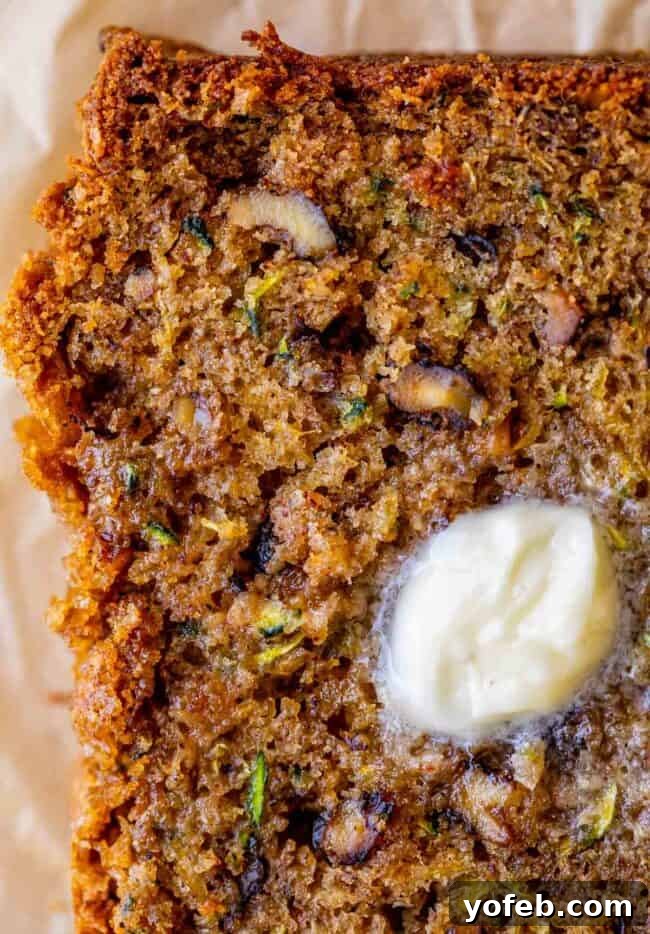 Heavenly Zucchini Bread 5 overhead shot of a slice of zucchini bread topped with melting butter.