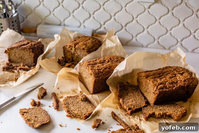 Heavenly Zucchini Bread 9 four loaves of zucchini bread on a counter with slices cut off.