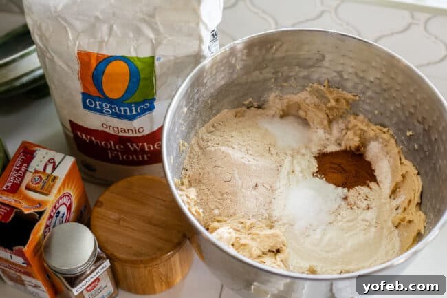 Dreamy White Chocolate Chip Treats 15 dry ingredients on top of wet ingredients in a stand mixer for cookie dough, plus flour and other ingredients on the side