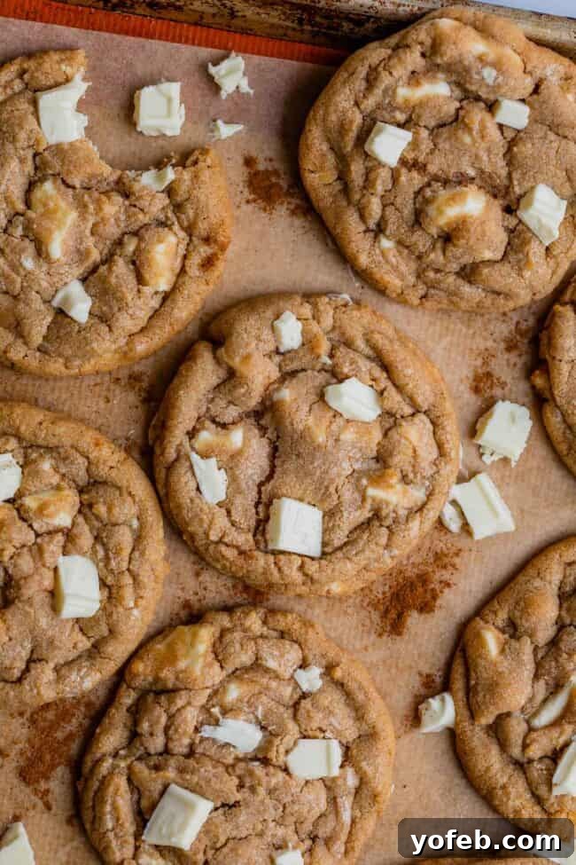Dreamy White Chocolate Chip Treats 19 cinnamon white chocolate chip cookies on parchment paper