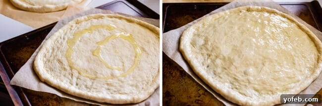 The Ultimate Homemade Pizza Ready When You Are 14 Raw pizza dough with olive oil drizzled and rubbed over its surface, highlighting the crust.