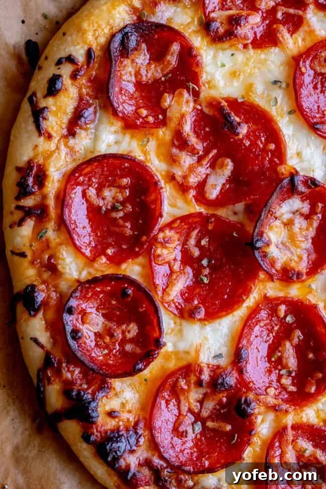 The Ultimate Homemade Pizza Ready When You Are 3 Close-up of an easy homemade pizza recipe with perfectly cooked pepperoni and golden cheese.