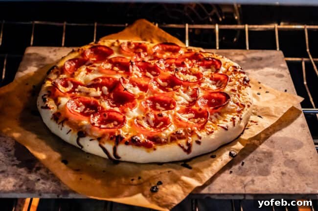 The Ultimate Homemade Pizza Ready When You Are 24 Homemade pizza baking inside an oven, resting directly on a hot pizza stone for optimal crispiness.