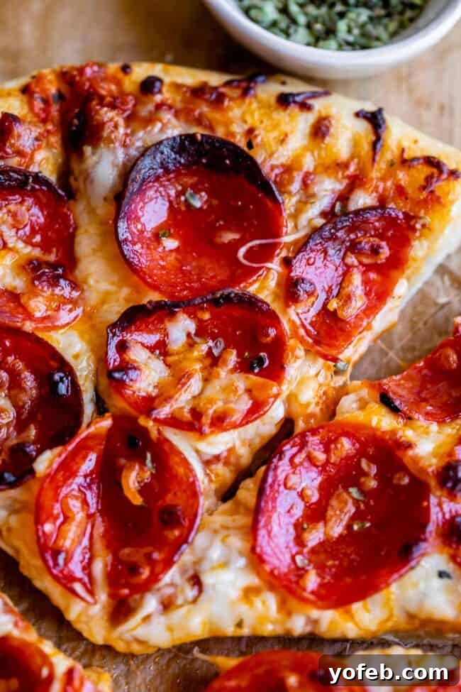 The Ultimate Homemade Pizza Ready When You Are 26 A freshly baked homemade pizza with pepperoni, resting on a wooden cutting board.