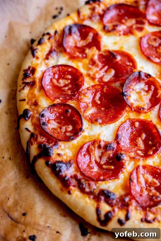 The Ultimate Homemade Pizza Ready When You Are 27 A vibrant homemade pizza with mozzarella and pepperoni, ready for slicing.