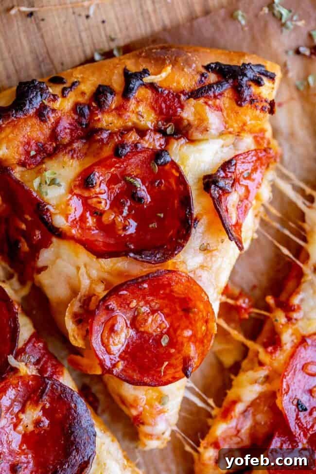 Foolproof Pizza Dough for Newbies 22 homemade pizza with pepperoni and cheese stretch.