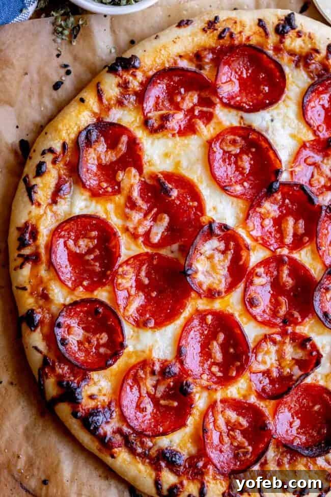 Foolproof Pizza Dough for Newbies 25 homemade pizza recipe with pepperoni, shot from overhead.