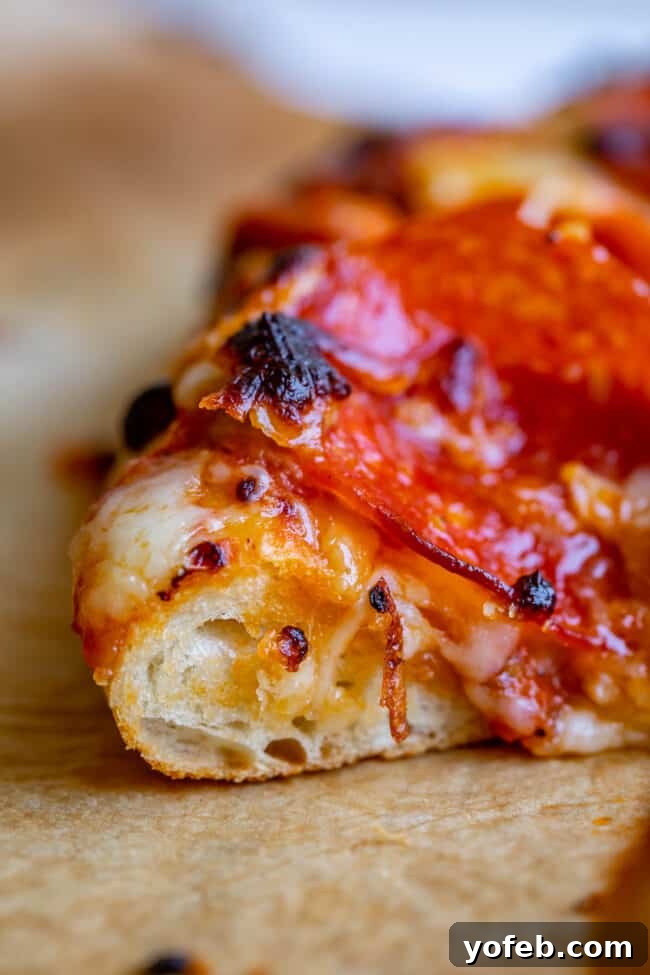 Foolproof Pizza Dough for Newbies 6 close up shot of pepperoni pizza on parchment paper.