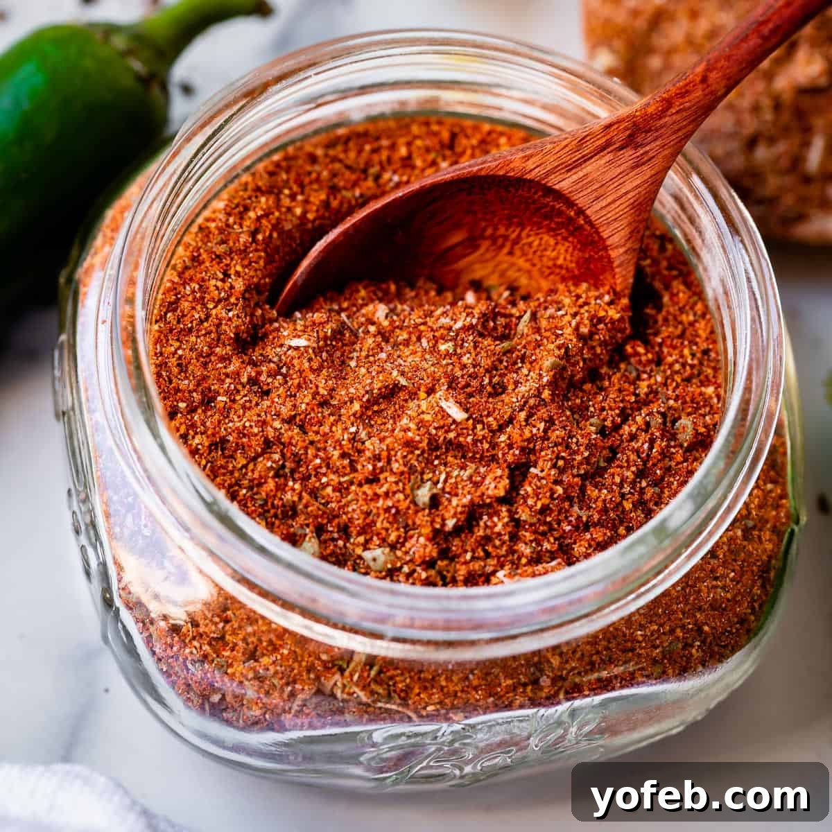 Elevate Your Tacos with Homemade Seasoning 4 Best homemade taco seasoning stored in a glass jar with a small wooden spoon, ready for use.
