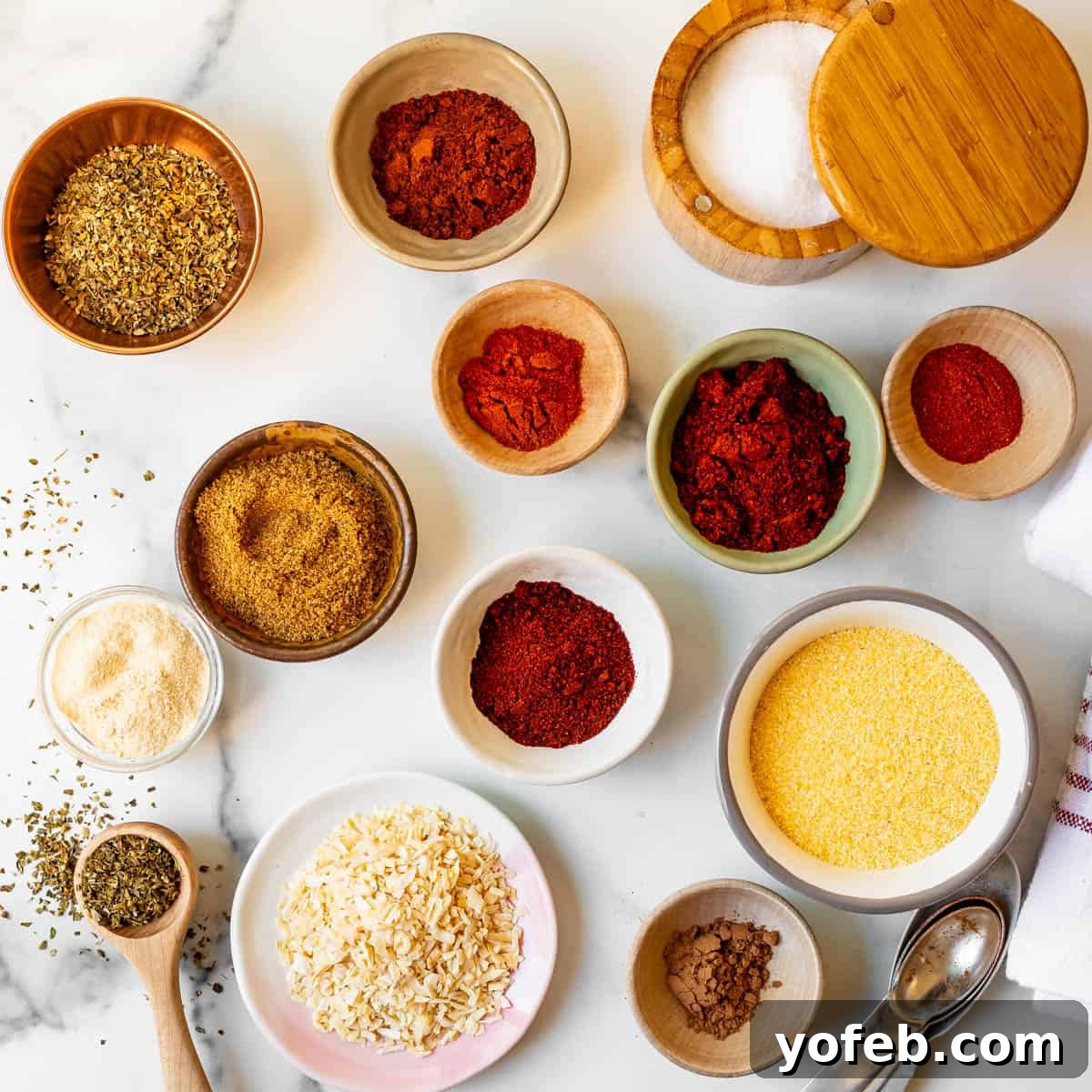 Elevate Your Tacos with Homemade Seasoning 9 Individual bowls of spices and ingredients for homemade taco seasoning arranged artfully on a counter.