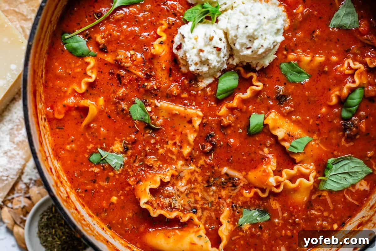 The Definitive Lasagna Soup 16 Top-down view of a large pot brimming with homemade lasagna soup, steaming gently.
