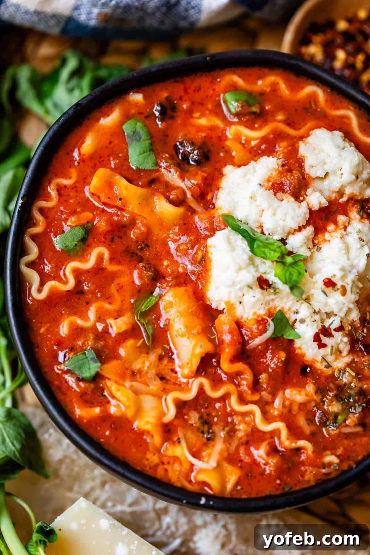 The Definitive Lasagna Soup 7 A ceramic bowl filled to the brim with homemade easy lasagna soup, ready to be enjoyed.