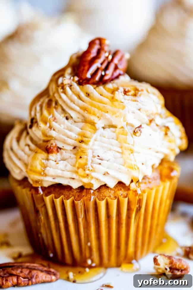 Maple Pecan Frosted Pumpkin Spice Cupcakes 2 Moist pumpkin cupcakes topped with rich maple pecan frosting, perfect for fall celebrations.