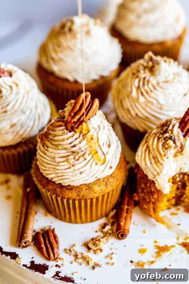 Maple Pecan Frosted Pumpkin Spice Cupcakes 13 A festive spread of pumpkin cupcakes with maple pecan frosting for a fall gathering.