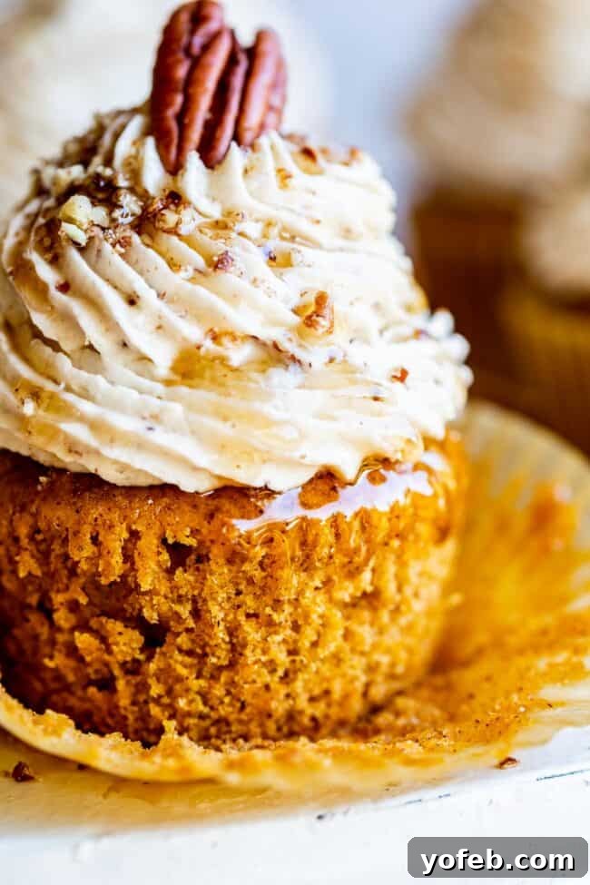 Maple Pecan Frosted Pumpkin Spice Cupcakes 8 Closeup of a perfect pumpkin cupcake, highlighting its moist interior and delicious frosting.