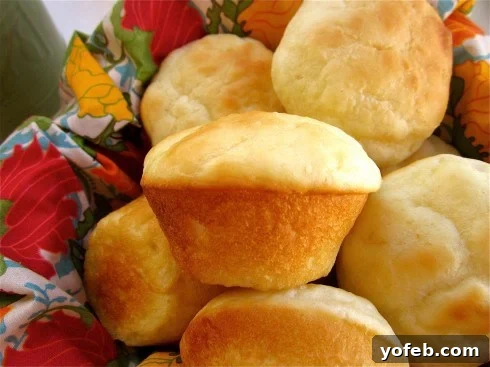 Delicious One-Hour Dinner Rolls A basket overflowing with warm, golden-brown dinner rolls, lined with a soft cloth napkin.