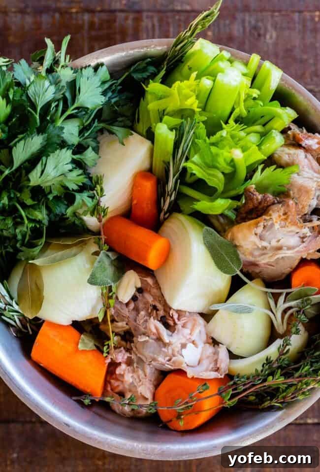 Homemade Turkey Stock: Elevate Your Thanksgiving Leftovers. Learn how easy it is to make Turkey Stock from the bones of your Thanksgiving turkey! All you need is a picked over turkey carcass and some vegetables and herbs that you probably already have on hand from cooking your turkey. You are going to love using this flavorful turkey stock in your next soup! #turkey #stock #fromcarcass #recipe #forgravy #uses #fromneckandgiblets #homemade #slowcooker #crockpot #soup #howtomake #leftovers vegetables in stock pot for turkey stock recipe.