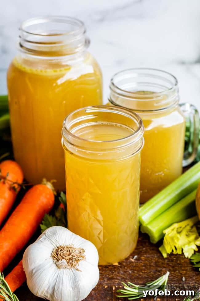 Homemade Turkey Stock: A Thanksgiving Leftover Essential. Learn how easy it is to make Turkey Stock from the bones of your Thanksgiving turkey! All you need is a picked over turkey carcass and some vegetables and herbs that you probably already have on hand from cooking your turkey. You are going to love using this flavorful turkey stock in your next soup! #turkey #stock #fromcarcass #recipe #forgravy #uses #fromneckandgiblets #homemade #slowcooker #crockpot #soup #howtomake #leftovers Turkey broth in three different Mason jars.