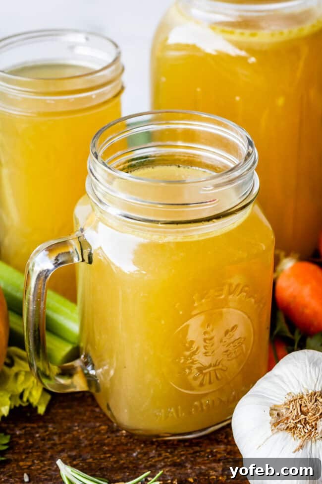 Homemade Turkey Stock: Storing Your Liquid Gold. Learn how easy it is to make Turkey Stock from the bones of your Thanksgiving turkey! All you need is a picked over turkey carcass and some vegetables and herbs that you probably already have on hand from cooking your turkey. You are going to love using this flavorful turkey stock in your next soup! #turkey #stock #fromcarcass #recipe #forgravy #uses #fromneckandgiblets #homemade #slowcooker #crockpot #soup #howtomake #leftovers turkey stock inside 3 Mason jars.